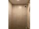 Shower stall featuring tile surround and modern shower head at 667 W Valleyview Ave, Littleton, CO 80120