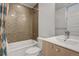 Modern bathroom featuring honeycomb tile, a tub/shower combo, and a sleek vanity at 3050 Wilson Ct # 1, Denver, CO 80205