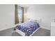 Bright bedroom featuring a cozy bed, large window, and minimalist decor at 3050 Wilson Ct # 1, Denver, CO 80205