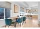 Dining room with table, seating, and view into kitchen with bar stool seating at 3050 Wilson Ct # 1, Denver, CO 80205