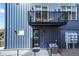Close up of a townhome's exterior, highlighting the private balcony with seating and modern design elements at 3050 Wilson Ct # 1, Denver, CO 80205