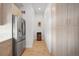 Hallway featuring hardwood floors, stainless steel refrigerator, and modern storage cabinets at 3050 Wilson Ct # 1, Denver, CO 80205