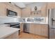 Modern kitchen featuring stainless steel appliances, subway tile backsplash and light wood cabinets at 3050 Wilson Ct # 1, Denver, CO 80205