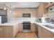 Contemporary kitchen featuring stainless steel appliances, white countertops, and sleek cabinetry at 3050 Wilson Ct # 1, Denver, CO 80205