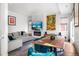 Open concept living and dining area with electric fireplace, hardwood floors, and modern decor at 3050 Wilson Ct # 1, Denver, CO 80205