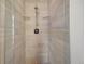 Modern walk-in shower featuring light stone-look tile, glass doors, and rainfall shower head at 3050 Wilson Ct # 1, Denver, CO 80205