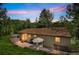 Charming backyard with a patio, outdoor dining set, and lush greenery, perfect for relaxation and entertainment at 7256 Aspen Meadow Dr, Evergreen, CO 80439