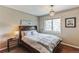 Cozy bedroom with natural light and hardwood floors, featuring a stylish chandelier at 7256 Aspen Meadow Dr, Evergreen, CO 80439