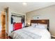 Well-lit bedroom with a queen-sized bed, a red dresser, and closet access, offering ample storage space at 7256 Aspen Meadow Dr, Evergreen, CO 80439