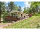 Charming single-Gathering home featuring a porch and outdoor seating at 7256 Aspen Meadow Dr, Evergreen, CO 80439