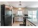 Bright kitchen featuring stainless appliances, white cabinetry, and sleek countertops at 7256 Aspen Meadow Dr, Evergreen, CO 80439