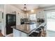 Bright kitchen featuring stainless appliances, bar seating, and access to the backyard at 7256 Aspen Meadow Dr, Evergreen, CO 80439