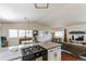 Open-concept living area featuring a modern kitchen, dining area, and comfortable living space at 7256 Aspen Meadow Dr, Evergreen, CO 80439