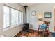 View of the wood burning stove and a comfortable rocking chair at 7256 Aspen Meadow Dr, Evergreen, CO 80439