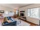 Spacious living room with natural light and hardwood floors at 7256 Aspen Meadow Dr, Evergreen, CO 80439
