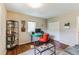 Functional office space with modern desk, bright orange chair, and shelving for organized work at 7256 Aspen Meadow Dr, Evergreen, CO 80439