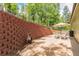 Outdoor patio area featuring a retaining wall, seating, umbrella, and a grill, perfect for entertaining at 7256 Aspen Meadow Dr, Evergreen, CO 80439