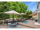 Large back deck with umbrellas, outdoor furniture, and lawn beyond at 6471 S Potomac Ct, Englewood, CO 80111