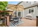 Back deck with outdoor furniture including table, chairs, grill, and umbrellas at 6471 S Potomac Ct, Englewood, CO 80111