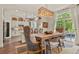 Elegant dining area with a modern light fixture, a kitchen view, and natural light at 6471 S Potomac Ct, Englewood, CO 80111
