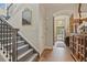 Entryway featuring staircase with iron railing, chandelier and view into the home at 6471 S Potomac Ct, Englewood, CO 80111