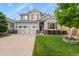 Charming two-story home featuring a well-manicured lawn, gray siding and a two car garage at 6471 S Potomac Ct, Englewood, CO 80111