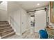 Bright hallway with stairs, sliding barn door, and stylish decor leading to other rooms at 6471 S Potomac Ct, Englewood, CO 80111