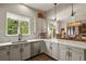 Kitchen featuring white cabinets, stainless steel appliances, backsplash and view into the breakfast room at 6471 S Potomac Ct, Englewood, CO 80111