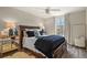 Comfortable bedroom with dark wood furniture, soft lighting, and neutral decor for a relaxing ambiance at 6471 S Potomac Ct, Englewood, CO 80111