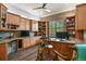 Spacious office with custom wood built-ins, desk and drawers, a decorative statue, and wood floors at 6471 S Potomac Ct, Englewood, CO 80111