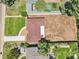 This aerial view shows the house with a brown roof and the surrounding yard, sidewalk, and street in a neighborhood at 2230 Niagara St, Denver, CO 80207