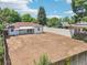 This backyard features a large, open space enclosed by a fence and a high, solid wall at 2230 Niagara St, Denver, CO 80207