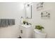 Modern bathroom featuring white vanity, sleek black fixtures, and botanical decor at 2230 Niagara St, Denver, CO 80207