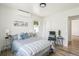 Bright bedroom featuring stylish decor, hardwood floors, and a comfortable queen bed with soft blue accents at 2230 Niagara St, Denver, CO 80207