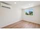 Minimalist bedroom featuring hardwood flooring and a bright window view at 2230 Niagara St, Denver, CO 80207