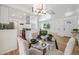 Bright dining area with a modern glass table set, upholstered chairs, with views of the kitchen and yard at 2230 Niagara St, Denver, CO 80207