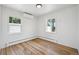 An empty bedroom featuring hardwood floors, bright window light, and neutral decor at 2230 Niagara St, Denver, CO 80207