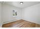 An empty bedroom featuring hardwood floors, bright window light, and neutral decor at 2230 Niagara St, Denver, CO 80207