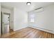 An empty bedroom featuring hardwood floors, bright window light, and neutral decor at 2230 Niagara St, Denver, CO 80207