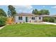 Charming one-story home featuring a lush green lawn, white brick exterior and brown roof at 2230 Niagara St, Denver, CO 80207