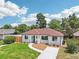 Charming single-story home boasting a well-maintained lawn, mature trees, and inviting curb appeal at 2230 Niagara St, Denver, CO 80207