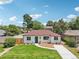 Charming single-story home boasting a well-maintained lawn, mature trees, and inviting curb appeal at 2230 Niagara St, Denver, CO 80207