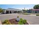 This is an exterior view of a building with a parking lot, landscaping, restaurants and a ice cream shop at 2230 Niagara St, Denver, CO 80207