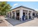 This shows an exterior view of a restaurant, with an outdoor seating area, a USPS mailbox, and cars driving down the street at 2230 Niagara St, Denver, CO 80207