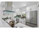 Modern kitchen with stainless steel appliances and stylish green tile backsplash at 2230 Niagara St, Denver, CO 80207
