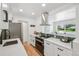 Bright kitchen with a view, featuring stainless steel appliances and hardwood floors at 2230 Niagara St, Denver, CO 80207