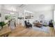 Bright, open-concept living room with hardwood floors, a view of the kitchen and a dining area at 2230 Niagara St, Denver, CO 80207