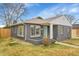 Charming gray brick single-story home with a well-manicured lawn and inviting blue door at 5345 E Thrill Pl, Denver, CO 80207