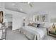 Bright main bedroom featuring a walk-in closet, ensuite bathroom, and a neutral color palette at 5345 E Thrill Pl, Denver, CO 80207