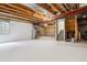 Unfinished basement ready for customization with exposed ceiling and concrete walls at 570 Clarendon Loop, Castle Pines, CO 80108